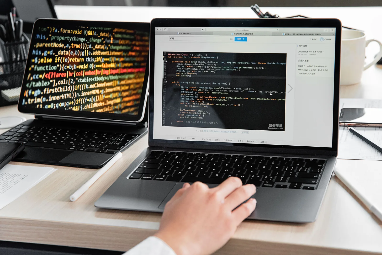 Software development and application code displayed on laptops